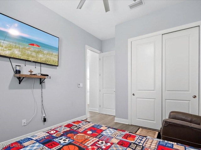 836 14th St SE, Naples, FL 34117 - bedroom with light wood-type flooring, baseboards, a closet, and a ceiling fan
