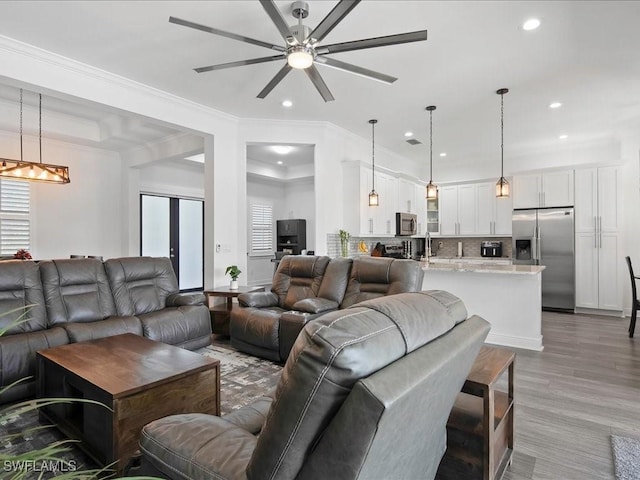 836 14th St SE, Naples, FL 34117 - living area featuring plenty of natural light, recessed lighting, ornamental molding, ceiling fan, and a chandelier