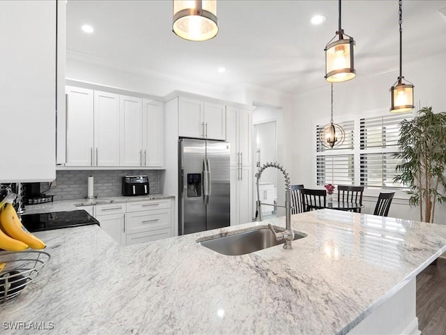 836 14th St SE, Naples, FL 34117 - kitchen featuring stainless steel fridge with ice dispenser, a sink, backsplash, light stone counters, and pendant lighting