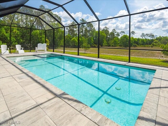 836 14th St SE, Naples, FL 34117 - outdoor pool with a patio area, glass enclosure, and view of wooded area