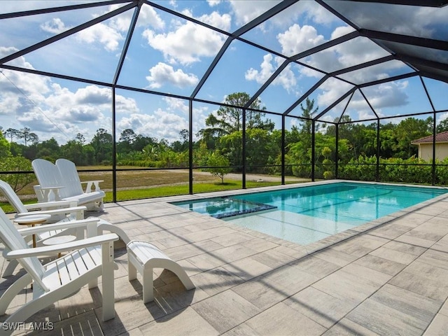 836 14th St SE, Naples, FL 34117 - view of pool with a patio, view of wooded area, a pool with connected hot tub, and glass enclosure