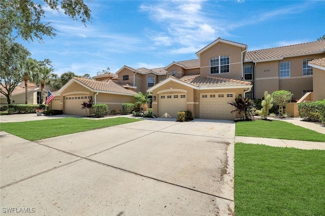 8560 Danbury Blvd Unit 202, Naples, FL 34120 - view of front of home featuring stucco siding, a tiled roof, concrete driveway, a front yard, and a garage