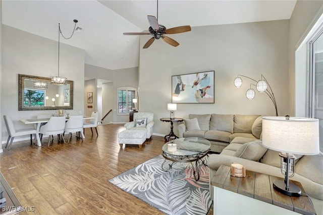 8560 Danbury Blvd Unit 202, Naples, FL 34120 - living room with wood finished floors, ceiling fan, high vaulted ceiling, a chandelier, and baseboards