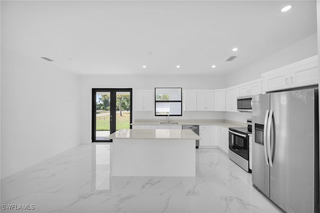 3201 14th St W, Lehigh Acres, FL 33971 - kitchen with stainless steel appliances, a center island, recessed lighting, light countertops, and white cabinetry