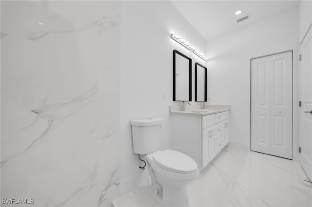 3201 14th St W, Lehigh Acres, FL 33971 - bathroom with marble finish floors, vanity, toilet, and baseboards
