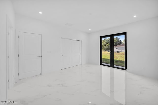3201 14th St W, Lehigh Acres, FL 33971 - unfurnished bedroom with marble tiled flooring, recessed lighting, and a closet