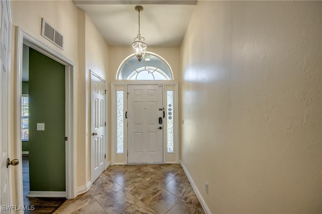 1812 SW 10th Ter, Cape Coral, FL 33991 - foyer entrance featuring baseboards, a chandelier, and marble look tiles