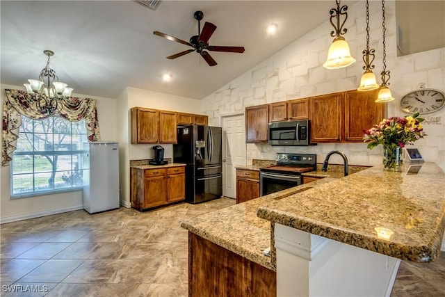 1812 SW 10th Ter, Cape Coral, FL 33991 - kitchen featuring appliances with stainless steel finishes, brown cabinets, a peninsula, a chandelier, and ceiling fan