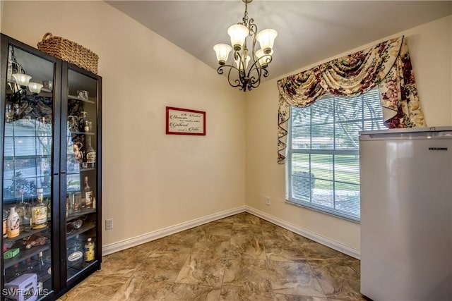 1812 SW 10th Ter, Cape Coral, FL 33991 - unfurnished dining area featuring a chandelier and baseboards