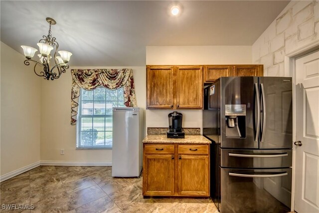 1812 SW 10th Ter, Cape Coral, FL 33991 - kitchen featuring stainless steel fridge with ice dispenser, brown cabinets, refrigerator, a chandelier, and light stone countertops