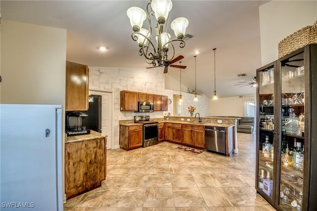 1812 SW 10th Ter, Cape Coral, FL 33991 - kitchen with stainless steel appliances, a sink, a peninsula, ceiling fan, and brown cabinets