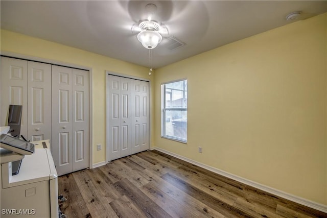 1812 SW 10th Ter, Cape Coral, FL 33991 - unfurnished bedroom with two closets, wood finished floors, and baseboards