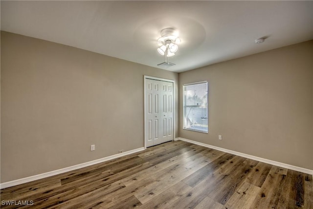 1812 SW 10th Ter, Cape Coral, FL 33991 - spare room featuring baseboards, wood finished floors, and a smoke detector