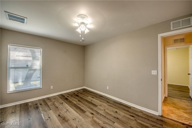 1812 SW 10th Ter, Cape Coral, FL 33991 - spare room with a ceiling fan, wood finished floors, and baseboards