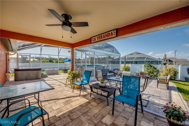 1812 SW 10th Ter, Cape Coral, FL 33991 - fenced backyard featuring a hot tub, a patio, a lanai, ceiling fan, and outdoor dining area