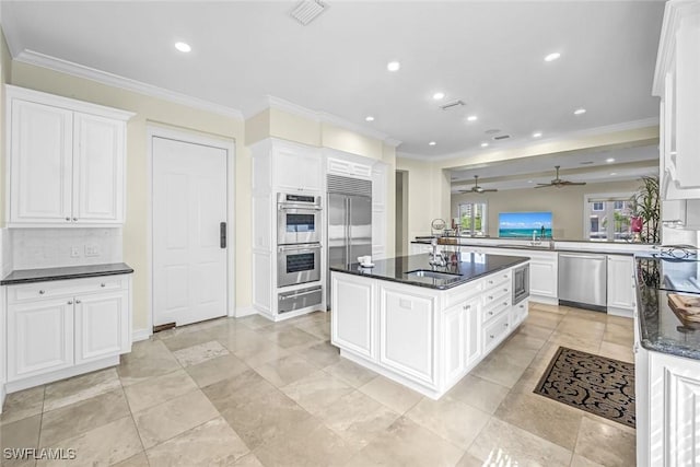 175 Topanga Dr, Bonita Springs, FL 34134 - kitchen featuring built in appliances, a ceiling fan, crown molding, white cabinets, and a warming drawer