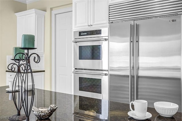 175 Topanga Dr, Bonita Springs, FL 34134 - kitchen with appliances with stainless steel finishes, white cabinetry, and dark stone counters
