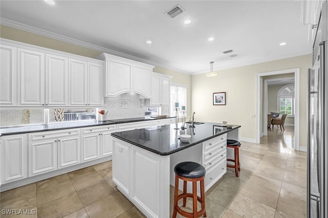 175 Topanga Dr, Bonita Springs, FL 34134 - kitchen with a breakfast bar area, decorative backsplash, white cabinetry, ornamental molding, and recessed lighting