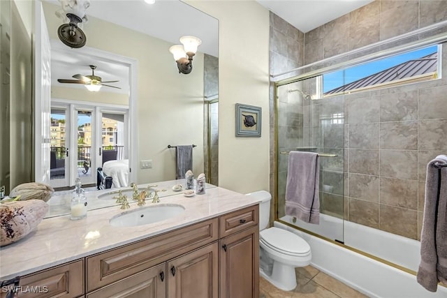 175 Topanga Dr, Bonita Springs, FL 34134 - full bathroom featuring vanity, shower / bath combination with glass door, toilet, ceiling fan, and tile patterned flooring