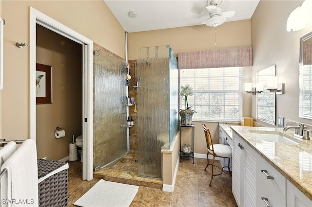 24712 Lakemont Cove Ln Unit 202, Bonita Springs, FL 34134 - full bathroom featuring toilet, vanity, ceiling fan, tiled shower, and plenty of natural light