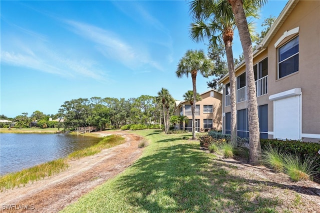 24712 Lakemont Cove Ln Unit 202, Bonita Springs, FL 34134 - surrounding community with a water view and a yard