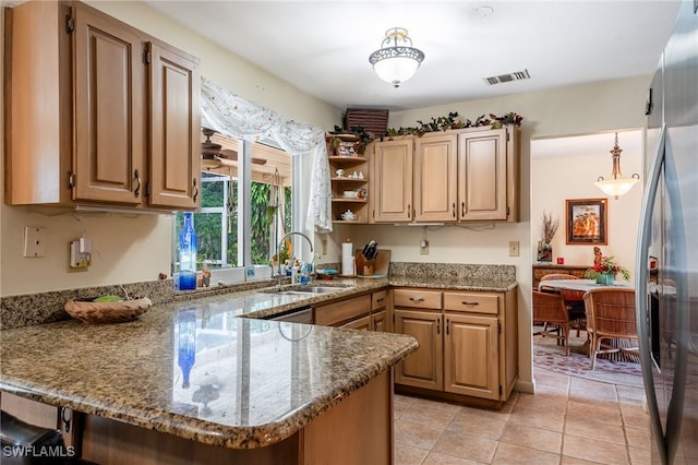 4559 Springview Cir, Labelle, FL 33935 - kitchen featuring a sink, a peninsula, freestanding refrigerator, and stone countertops