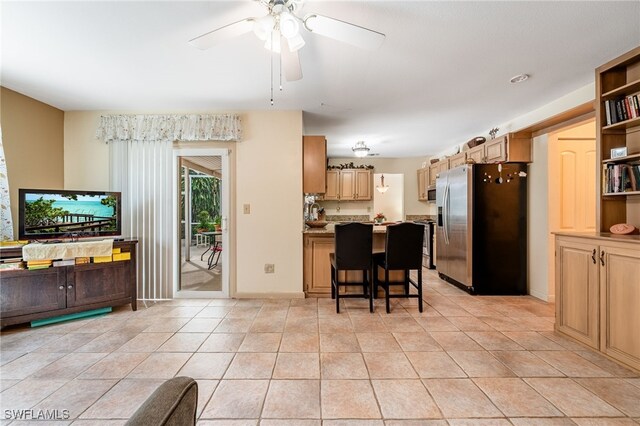4559 Springview Cir, Labelle, FL 33935 - kitchen featuring stainless steel appliances, ceiling fan, a peninsula, a kitchen breakfast bar, and light tile patterned flooring