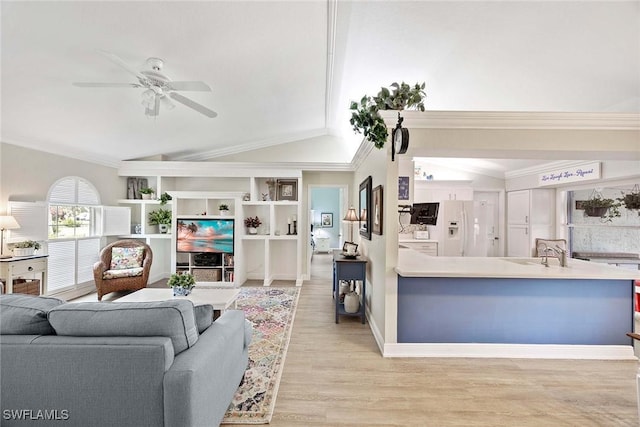 180 20th St SE, Naples, FL 34117 - living room featuring vaulted ceiling, a ceiling fan, crown molding, light wood-style floors, and baseboards