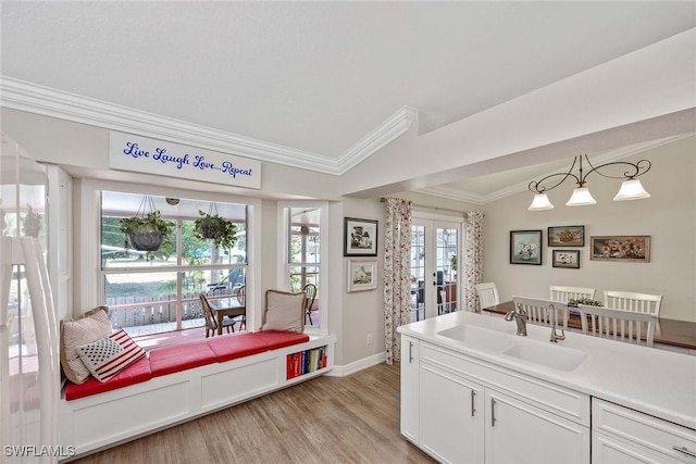 180 20th St SE, Naples, FL 34117 - dining room featuring ornamental molding, light wood-type flooring, french doors, vaulted ceiling, and baseboards