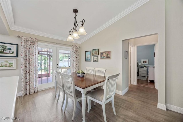 180 20th St SE, Naples, FL 34117 - dining space with french doors, lofted ceiling, ornamental molding, wood finished floors, and baseboards