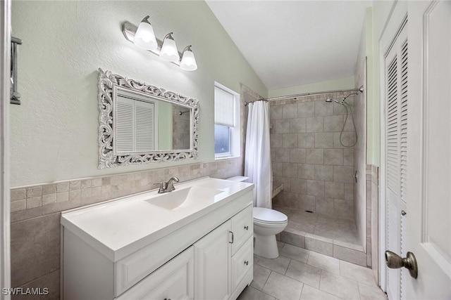 180 20th St SE, Naples, FL 34117 - full bathroom with vanity, toilet, a tile shower, tile patterned floors, and a closet