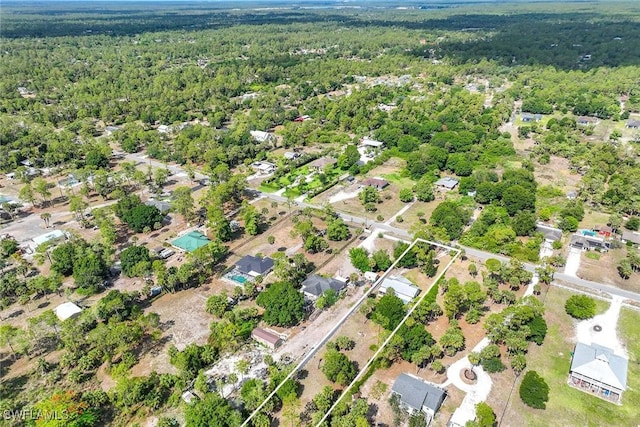 180 20th St SE, Naples, FL 34117 - aerial view of property and surrounding area with a heavily wooded area and property parcel outlined