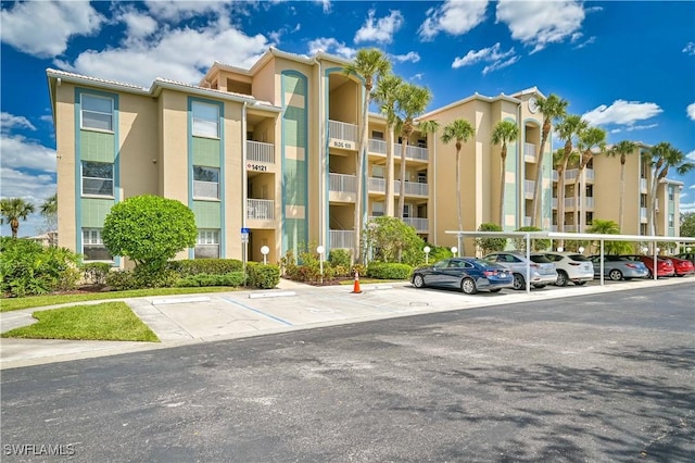 14121 Brant Point Cir Unit 1403, Fort Myers, FL 33919 - view of apartment building / complex featuring covered and uncovered parking