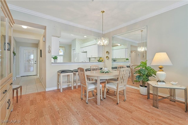 14121 Brant Point Cir Unit 1403, Fort Myers, FL 33919 - dining space with baseboards, light wood-style flooring, a chandelier, and crown molding