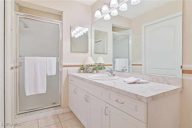 14121 Brant Point Cir Unit 1403, Fort Myers, FL 33919 - bathroom featuring a stall shower, vanity, and tile patterned flooring