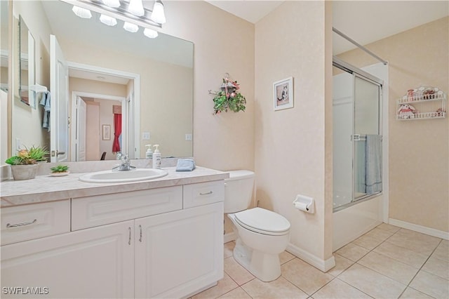 14121 Brant Point Cir Unit 1403, Fort Myers, FL 33919 - bathroom featuring tile patterned floors, vanity, toilet, bath / shower combo with glass door, and baseboards