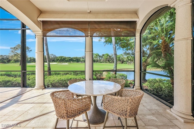 10072 Orchid Ridge Ln, Estero, FL 34135 - sunroom featuring golf course view, stone tile floors, and healthy amount of natural light
