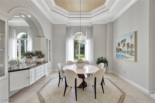 10072 Orchid Ridge Ln, Estero, FL 34135 - dining room featuring inlaid floor details, a raised ceiling, baseboards, arched walkways, and ornamental molding
