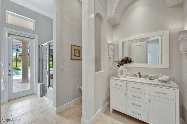 10072 Orchid Ridge Ln, Estero, FL 34135 - full bath featuring vanity, a high ceiling, baseboards, tile patterned flooring, and decorative columns