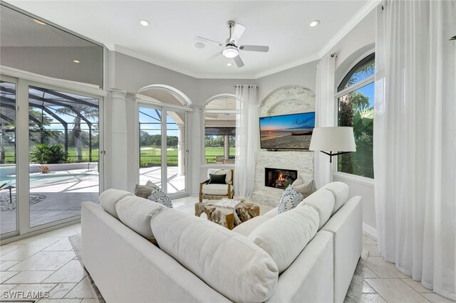 10072 Orchid Ridge Ln, Estero, FL 34135 - living area with stone tile floors, recessed lighting, a fireplace, ornamental molding, and a ceiling fan