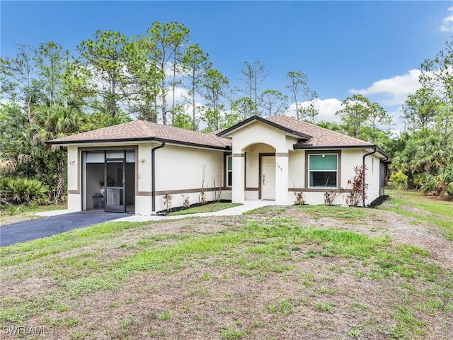145 33rd Ave NE, Naples, FL 34120 - single story home with stucco siding, a front yard, and a shingled roof