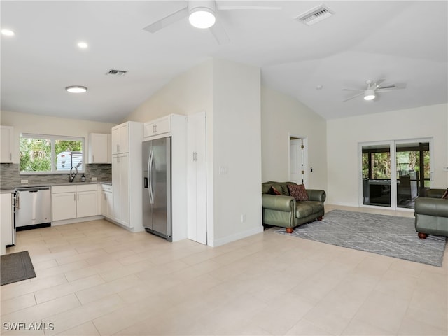 145 33rd Ave NE, Naples, FL 34120 - kitchen with stainless steel appliances, ceiling fan, vaulted ceiling, open floor plan, and a sink