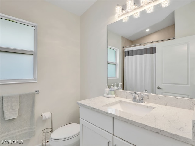 145 33rd Ave NE, Naples, FL 34120 - bathroom with vanity, toilet, and curtained shower