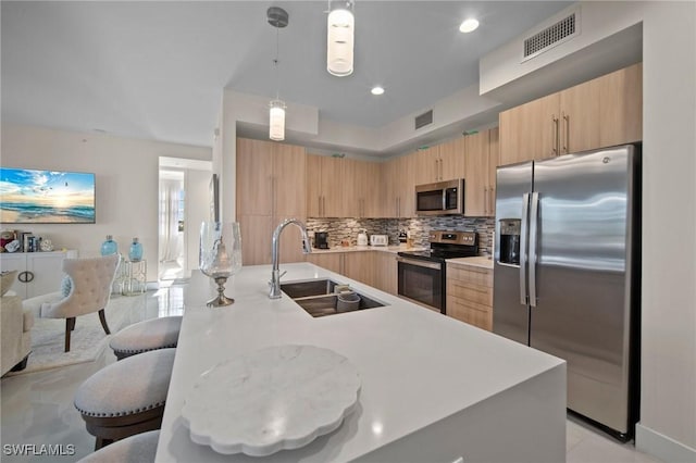 15901 Royal Pointe Ln Unit 301, Fort Myers, FL 33908 - kitchen with appliances with stainless steel finishes, a sink, light brown cabinets, and recessed lighting