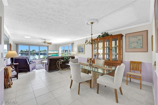 1829 SE 41st St Unit 1I, Cape Coral, FL 33904 - dining area with ornamental molding, a textured ceiling, a chandelier, light tile patterned floors, and a ceiling fan