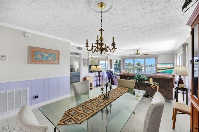 1829 SE 41st St Unit 1I, Cape Coral, FL 33904 - dining area featuring a chandelier, crown molding, light tile patterned floors, a ceiling fan, and a textured ceiling