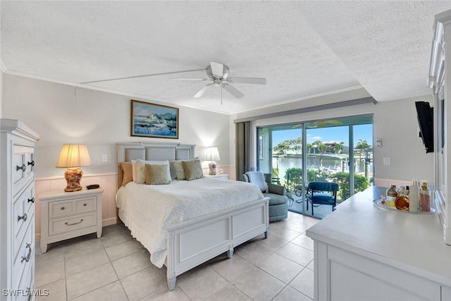 1829 SE 41st St Unit 1I, Cape Coral, FL 33904 - bedroom featuring access to outside, light tile patterned floors, a wainscoted wall, a textured ceiling, and crown molding