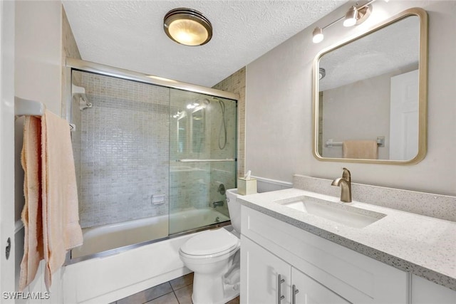 1829 SE 41st St Unit 1I, Cape Coral, FL 33904 - full bath with vanity, bath / shower combo with glass door, tile patterned floors, toilet, and a textured ceiling