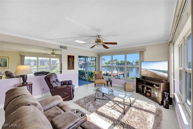 1829 SE 41st St Unit 1I, Cape Coral, FL 33904 - living area with ceiling fan, crown molding, tile patterned floors, a wainscoted wall, and a textured ceiling