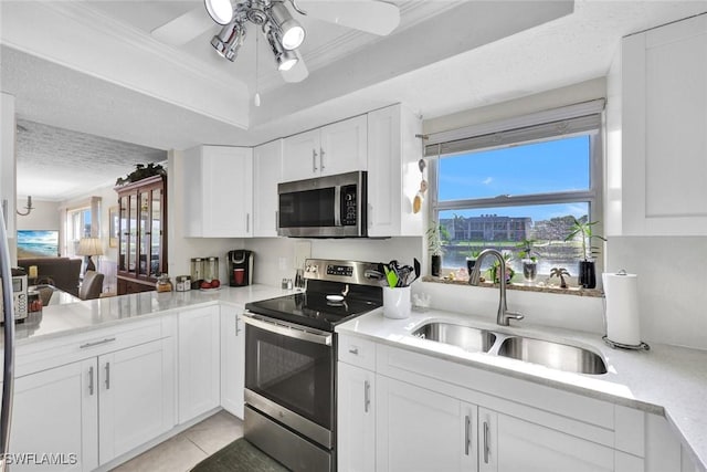 1829 SE 41st St Unit 1I, Cape Coral, FL 33904 - kitchen with stainless steel appliances, a sink, ceiling fan, light countertops, and white cabinets
